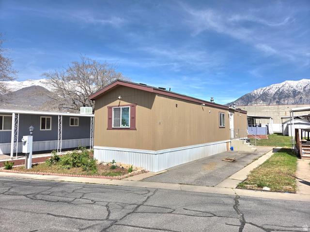 597 North State Street, Unit 67 Orem, UT 84057 - Photo 5 of 23 View of home's exterior with a mountain view and a porch