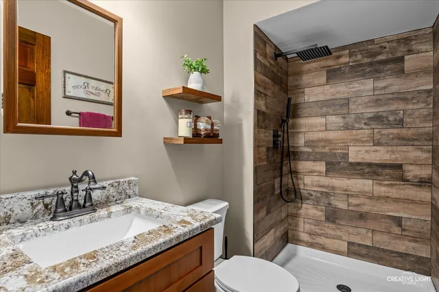 a bathroom with a sink toilet and shower