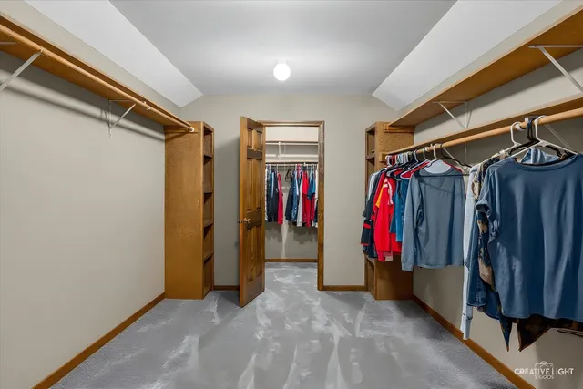 a view of walk in closet with clothes