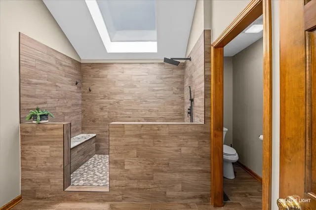 a bathroom with a toilet and a shower