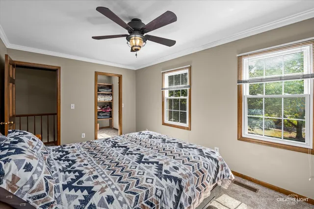 a bedroom with a large bed and a window