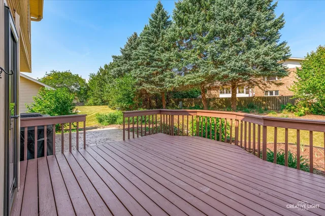 a view of wooden deck and a backyard