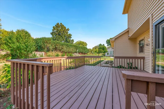 a view of a house with a yard and deck