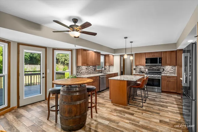 a living room with couches a dining table chairs and kitchen view