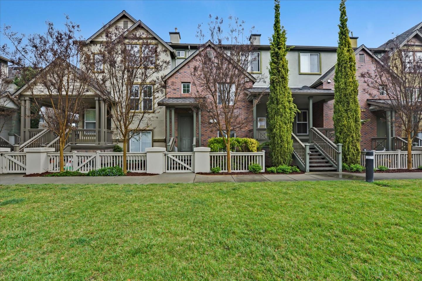 a view of a house with a big yard and large trees
