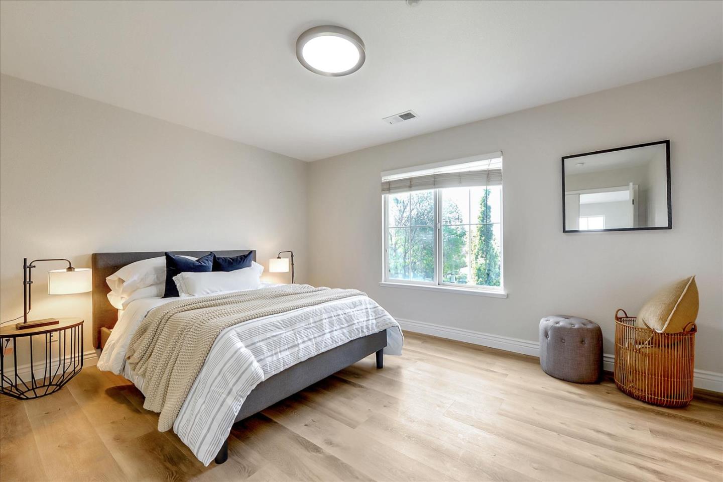 2276 Towne Circle Mountain View, CA 94040 - Photo 18 of 37 a spacious bedroom with a bed and window