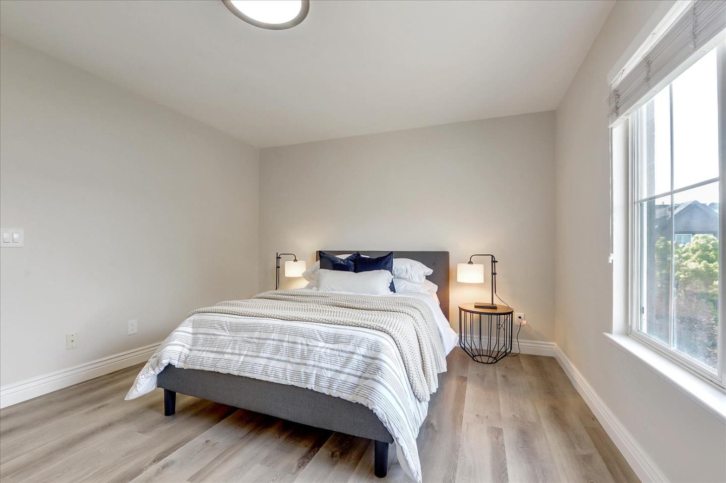 2276 Towne Circle Mountain View, CA 94040 - Photo 20 of 37 a bedroom with a bed and a large window