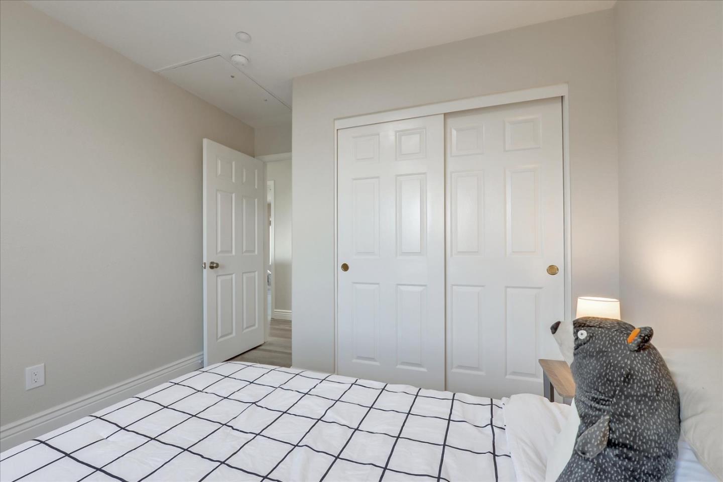 2276 Towne Circle Mountain View, CA 94040 - Photo 23 of 37 a bedroom with a bed and a lamp