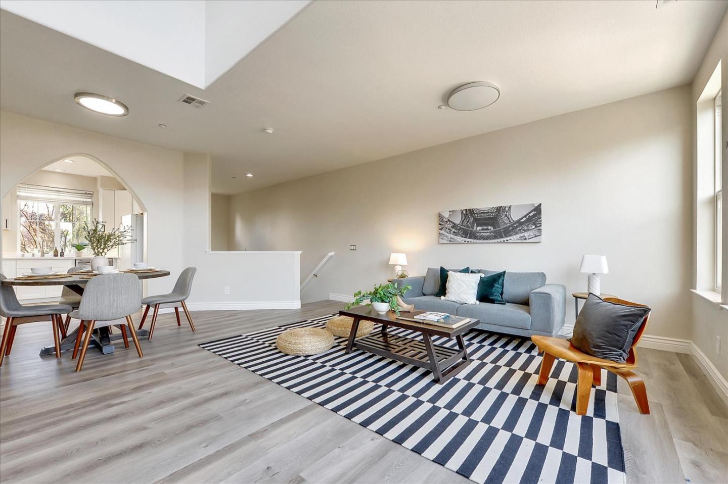 2276 Towne Circle Mountain View, CA 94040 - Photo 8 of 37 a living room with furniture a dining table and wooden floor