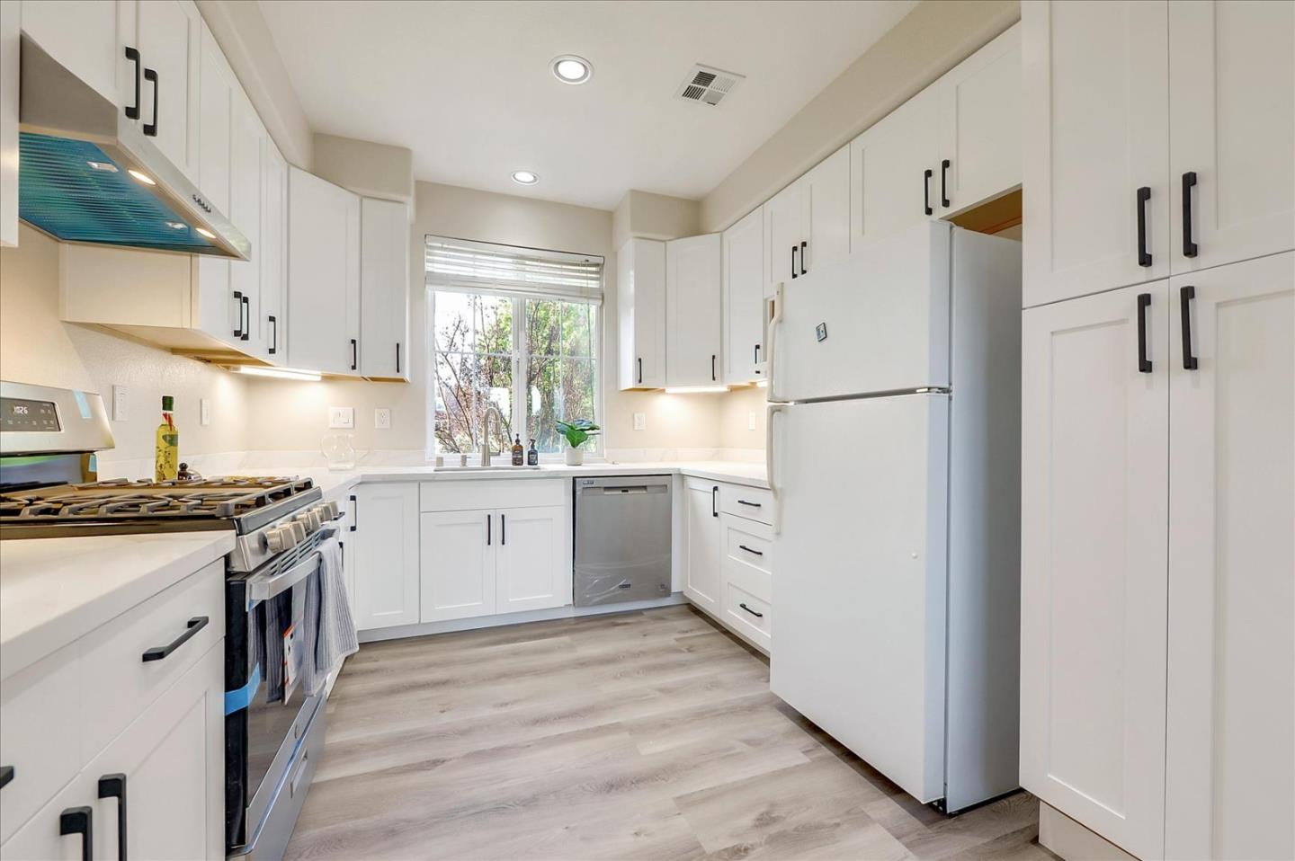 2276 Towne Circle Mountain View, CA 94040 - Photo 10 of 37 a kitchen with white cabinets and white appliances