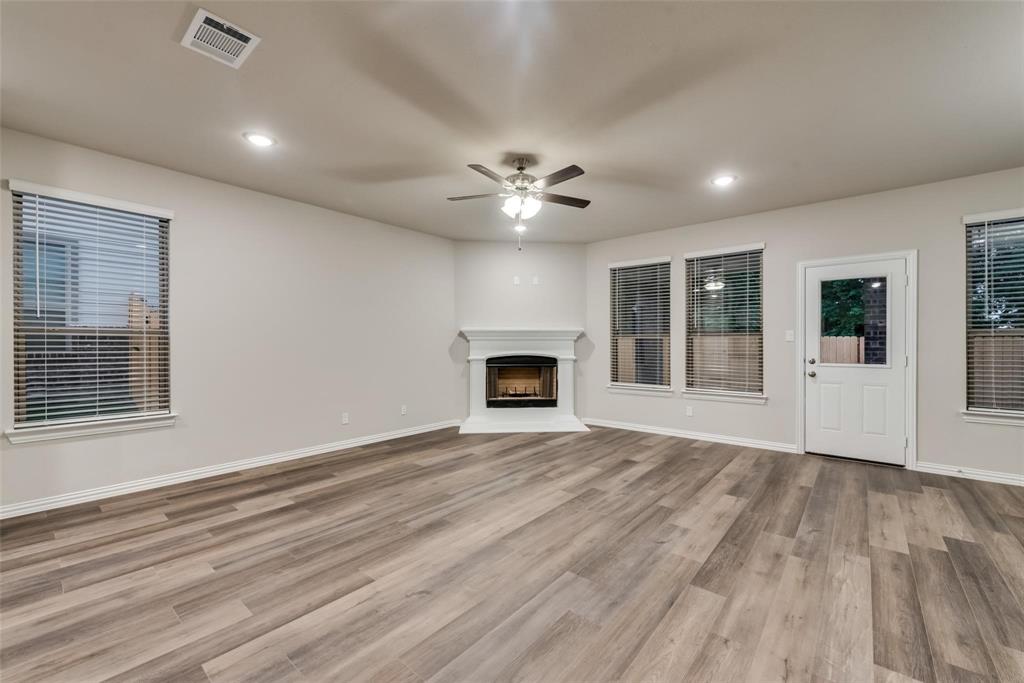 739 Copley Street Sherman, TX 75090 - Photo 10 of 31 a view of an empty room with a fireplace and a window