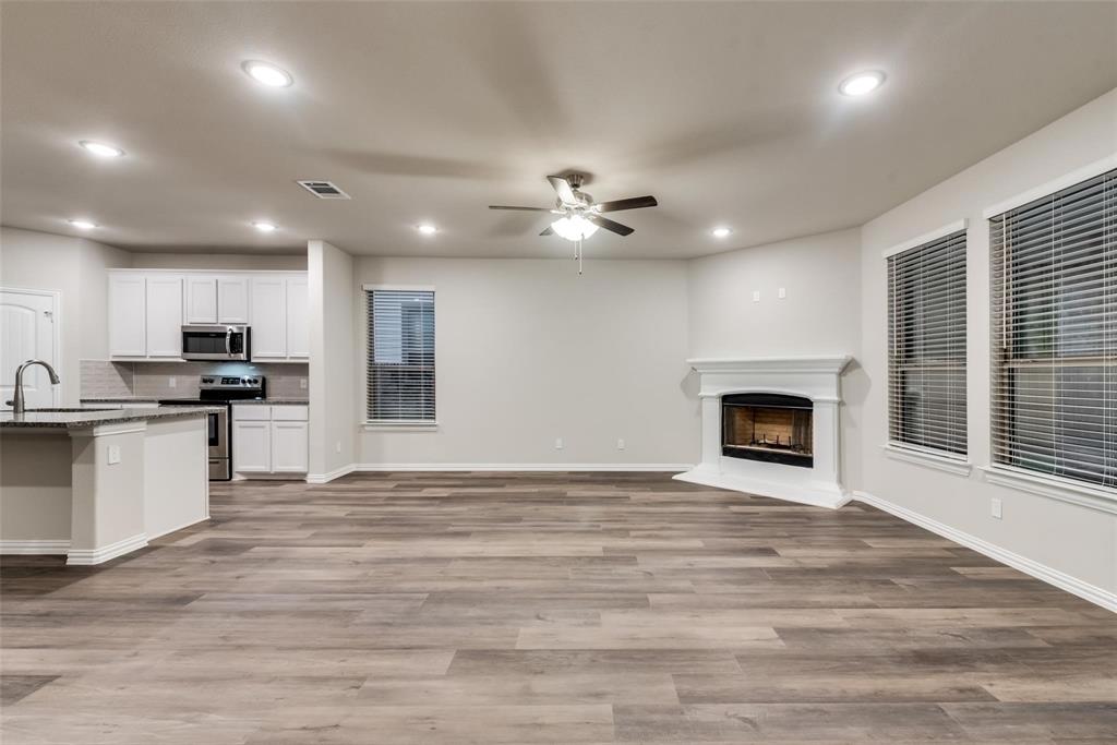 739 Copley Street Sherman, TX 75090 - Photo 11 of 31 a view of an empty room with kitchen and a fireplace