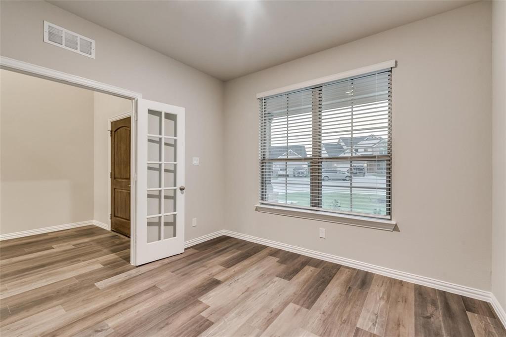 739 Copley Street Sherman, TX 75090 - Photo 17 of 31 an empty room with wooden floor and windows