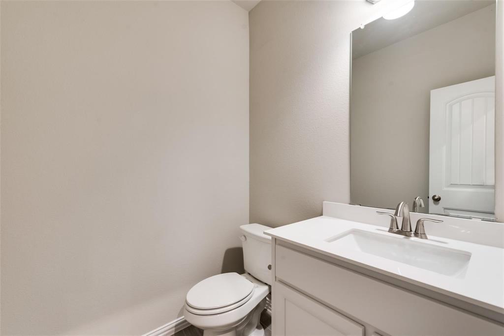 739 Copley Street Sherman, TX 75090 - Photo 18 of 31 a white toilet sitting next to a bathroom sink