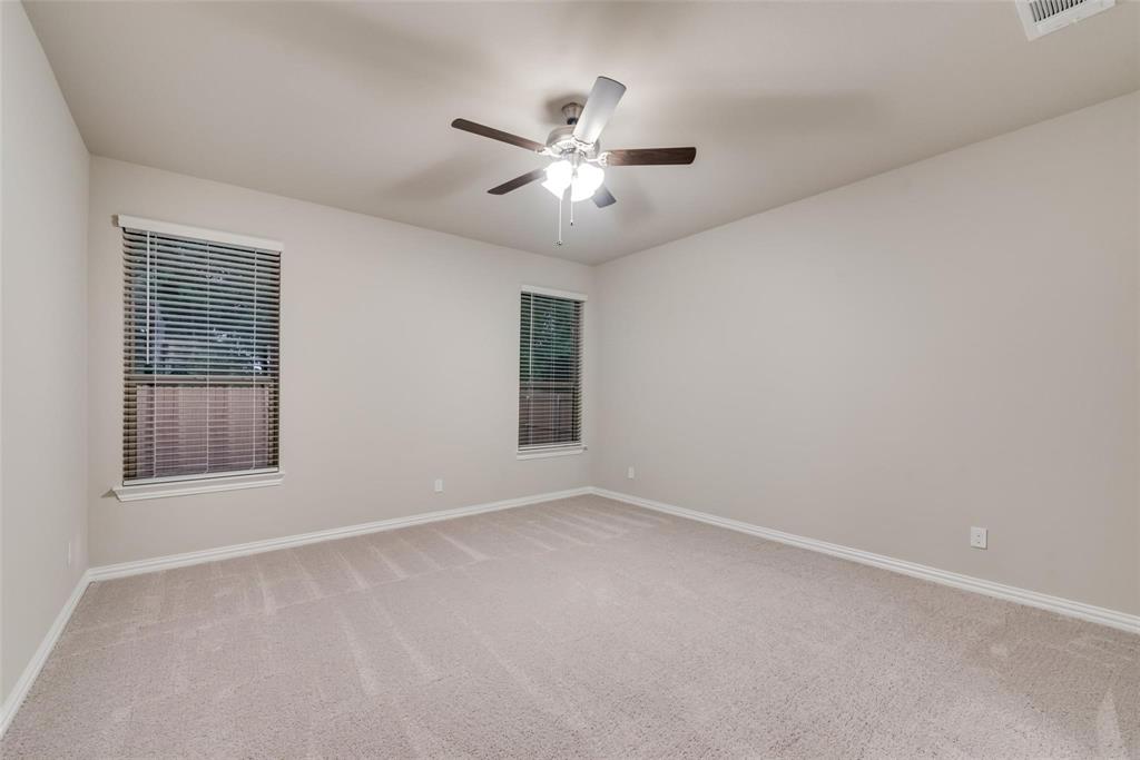 739 Copley Street Sherman, TX 75090 - Photo 19 of 31 an empty room with ceiling fan and window