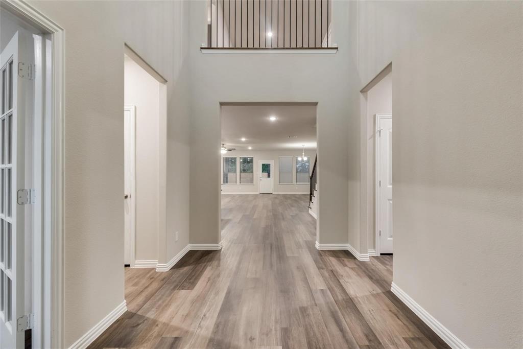 739 Copley Street Sherman, TX 75090 - Photo 5 of 31 a view of a hallway with wooden floor and staircase