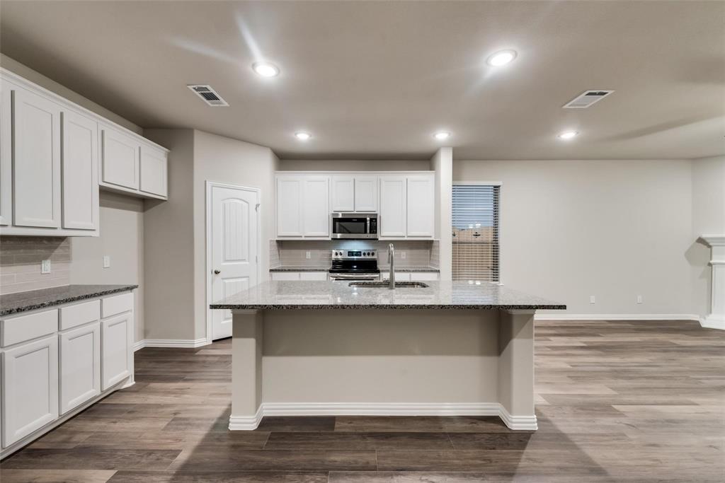 739 Copley Street Sherman, TX 75090 - Photo 7 of 31 a large kitchen with kitchen island a sink stainless steel appliances and cabinets