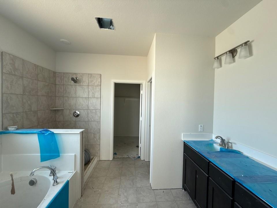 1333 Frio Drive Springtown, TX 76082 - Photo 6 of 7 a bathroom with a granite countertop sink a toilet and shower