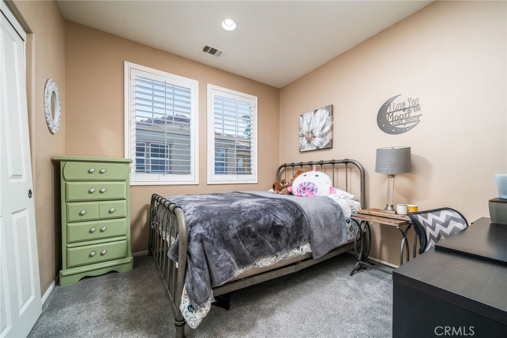16001 Chase Road, Unit 72 Fontana, CA 92336 - Photo 16 of 43 a bedroom with a bed and a table