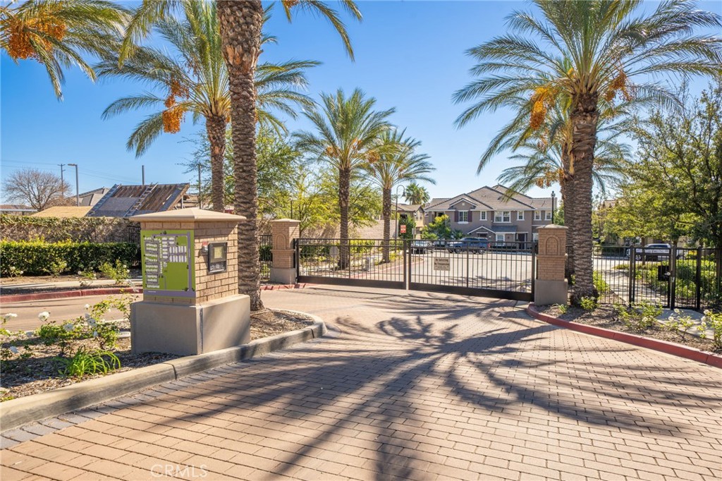 16001 Chase Road, Unit 72 Fontana, CA 92336 - Photo 23 of 43 a view of a backyard with a patio table and chairs under an umbrella