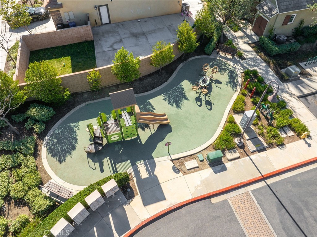 16001 Chase Road, Unit 72 Fontana, CA 92336 - Photo 39 of 43 an aerial view of a dining table and chairs with potted plants