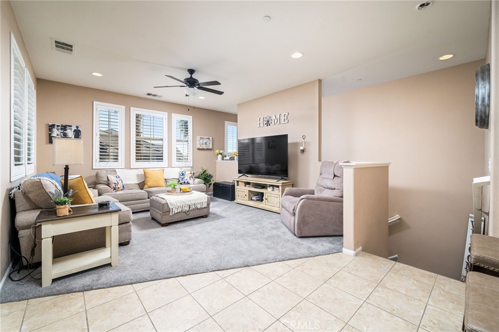 16001 Chase Road, Unit 72 Fontana, CA 92336 - Photo 5 of 43 a living room with furniture and a flat screen tv