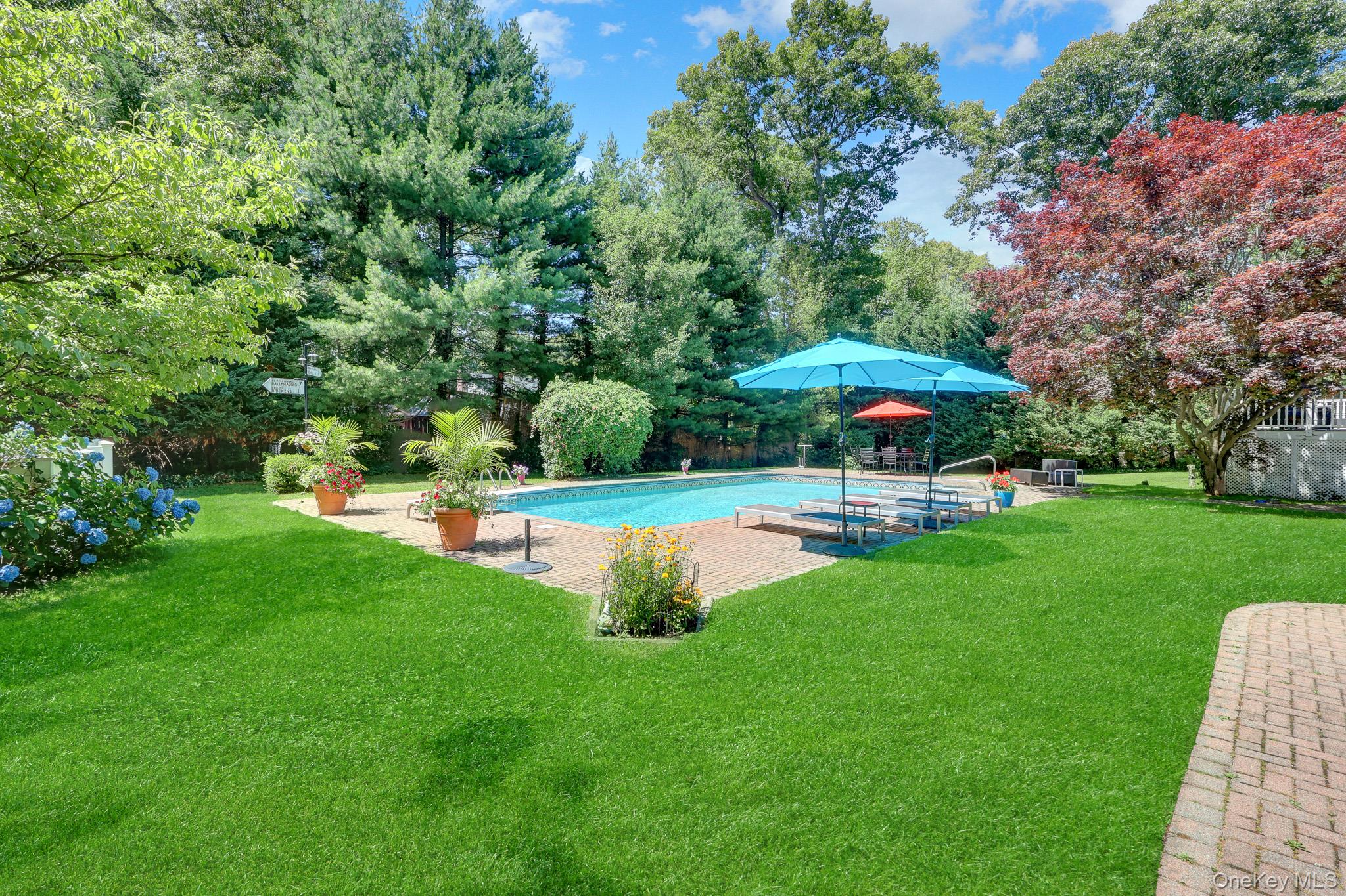 121 Old Field Road Huntington, NY 11743 - Photo 30 of 38 20’ x 40’ heated in-ground pool with a 2-year-old liner, robot cleaner, and a separate oil tank dedicated to pool heating. Entertain effortlessly with two spacious decks, a beautiful paver patio, and a storage shed surrounded by lush, park-like grounds.