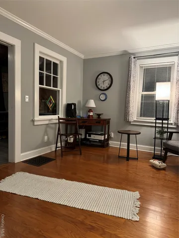 a living room with furniture rug and window