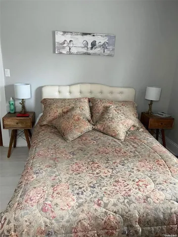 a large bed sitting in a bedroom next to a lamp