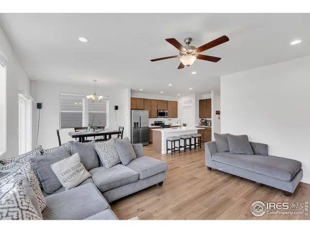 a living room with furniture and kitchen view