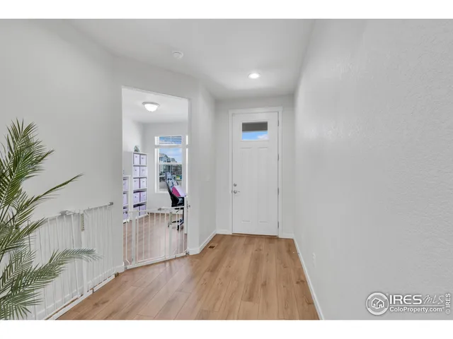 hallway with wooden floor and stairs