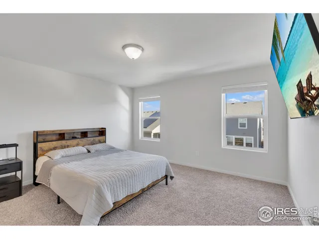 a bedroom with a bed and a painting on the wall