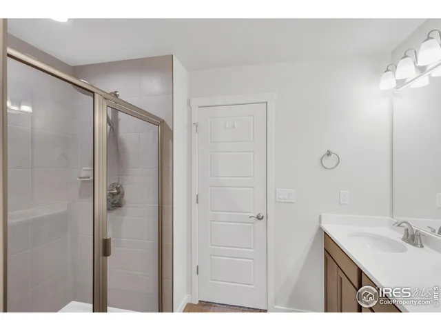 a bathroom with a granite countertop sink shower and a mirror