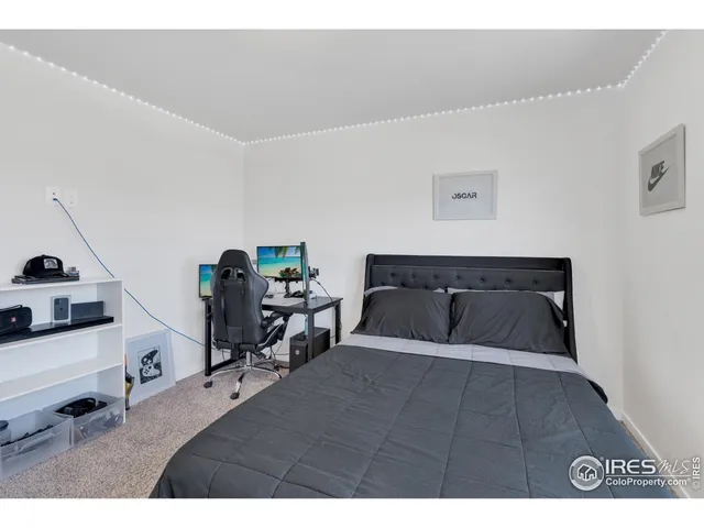 a bedroom with a bed and a lamp