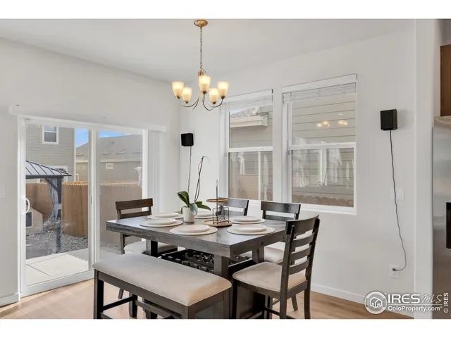 a view of a dining room with furniture wooden floor and chandelier