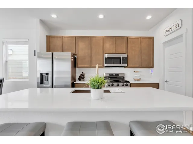 a kitchen with stainless steel appliances a refrigerator sink microwave and cabinets