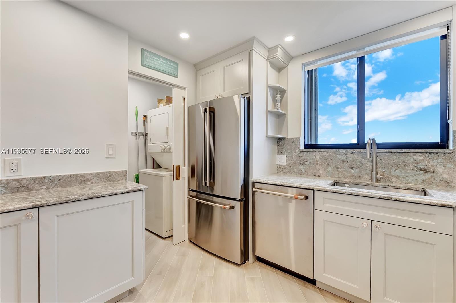 400 Ocean Trail Way, Unit 401 Jupiter, FL 33477 - Photo 15 of 28 a kitchen with stainless steel appliances granite countertop a refrigerator and a sink