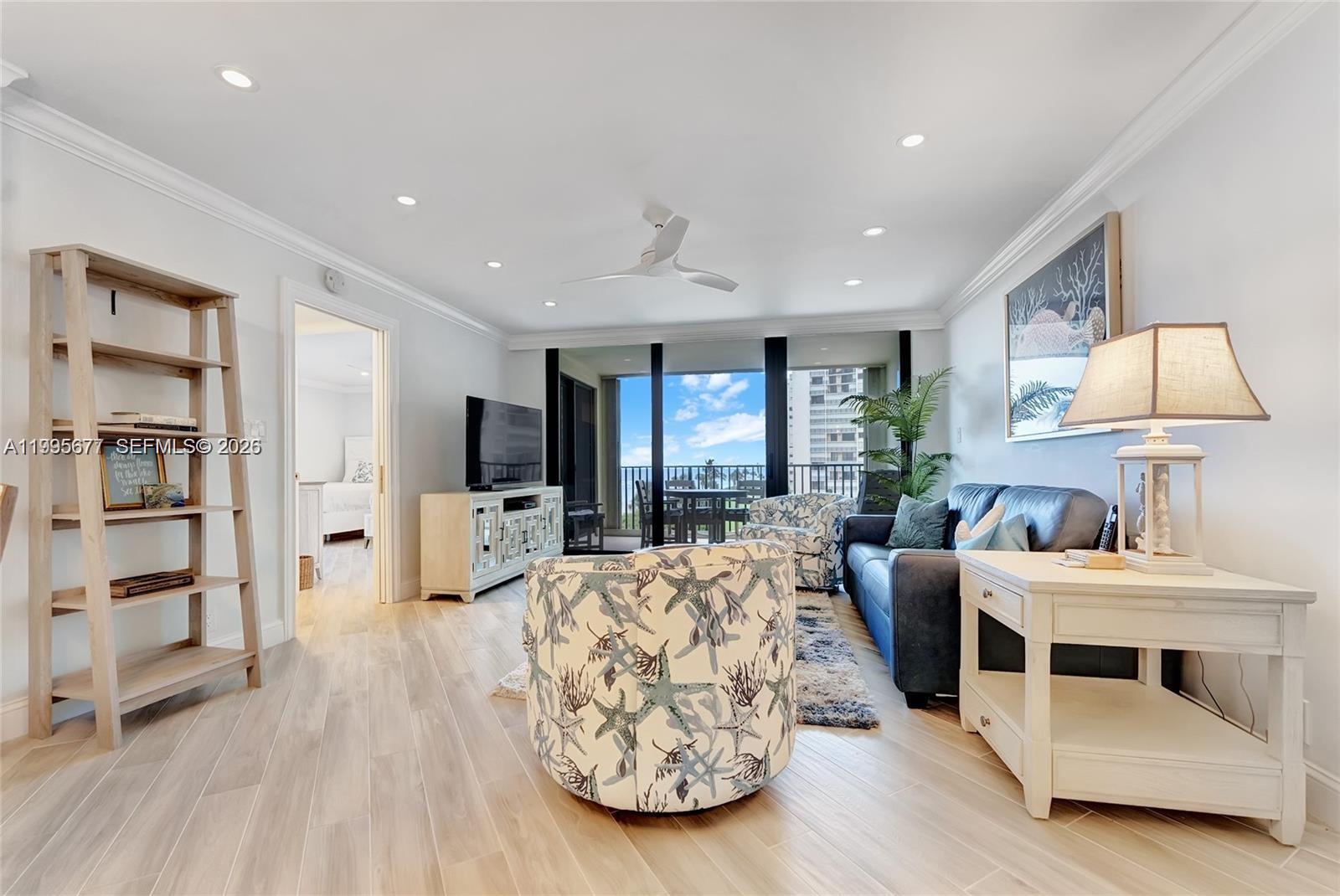 400 Ocean Trail Way, Unit 401 Jupiter, FL 33477 - Photo 16 of 28 a living room with furniture and a wooden floor