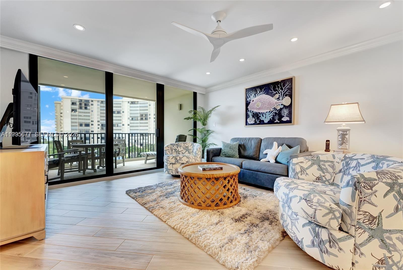 400 Ocean Trail Way, Unit 401 Jupiter, FL 33477 - Photo 18 of 28 a living room with furniture large window and wooden floor