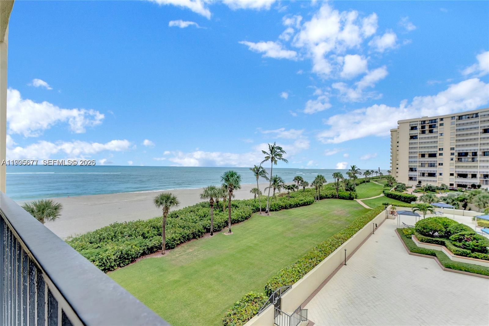 400 Ocean Trail Way, Unit 401 Jupiter, FL 33477 - Photo 2 of 28 a view of a lake with a building in the background