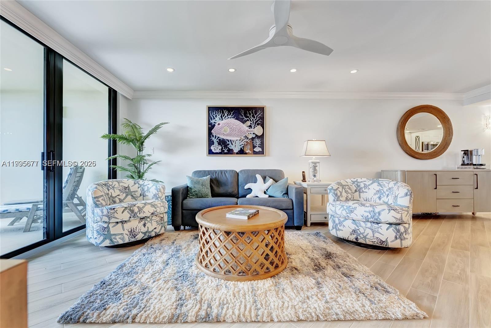 400 Ocean Trail Way, Unit 401 Jupiter, FL 33477 - Photo 22 of 28 a living room with furniture and a large window