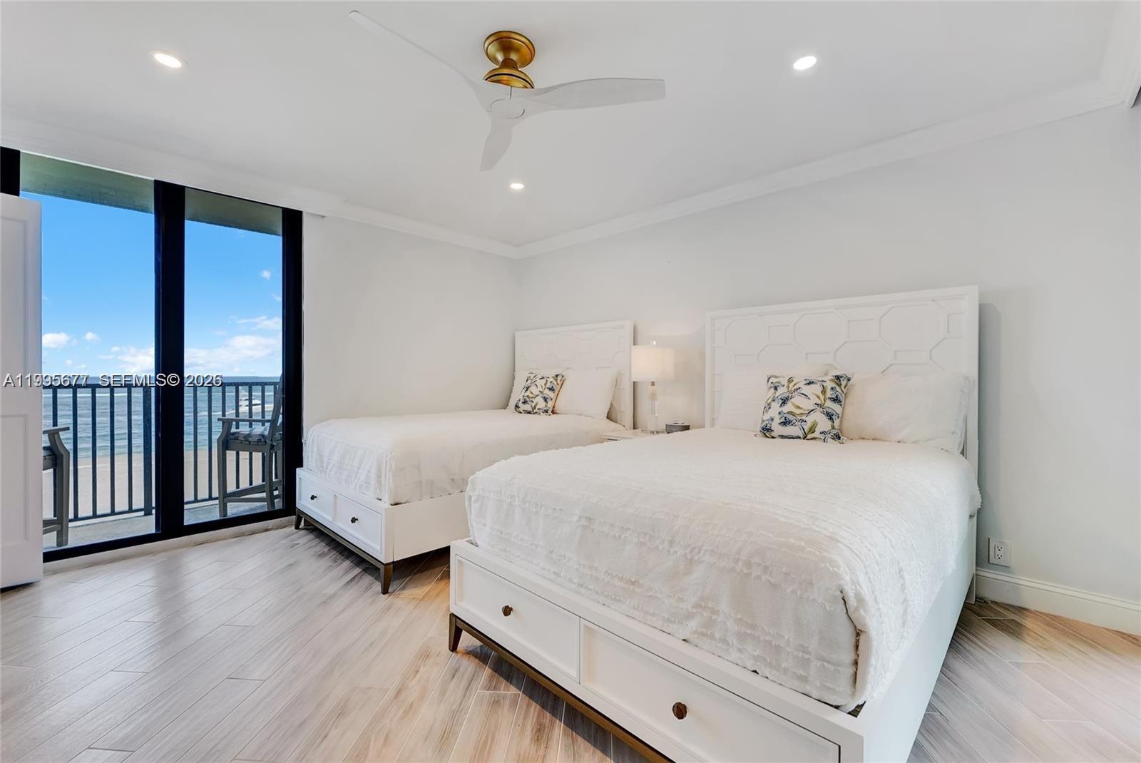 400 Ocean Trail Way, Unit 401 Jupiter, FL 33477 - Photo 23 of 28 a bed room with a bed and a large window