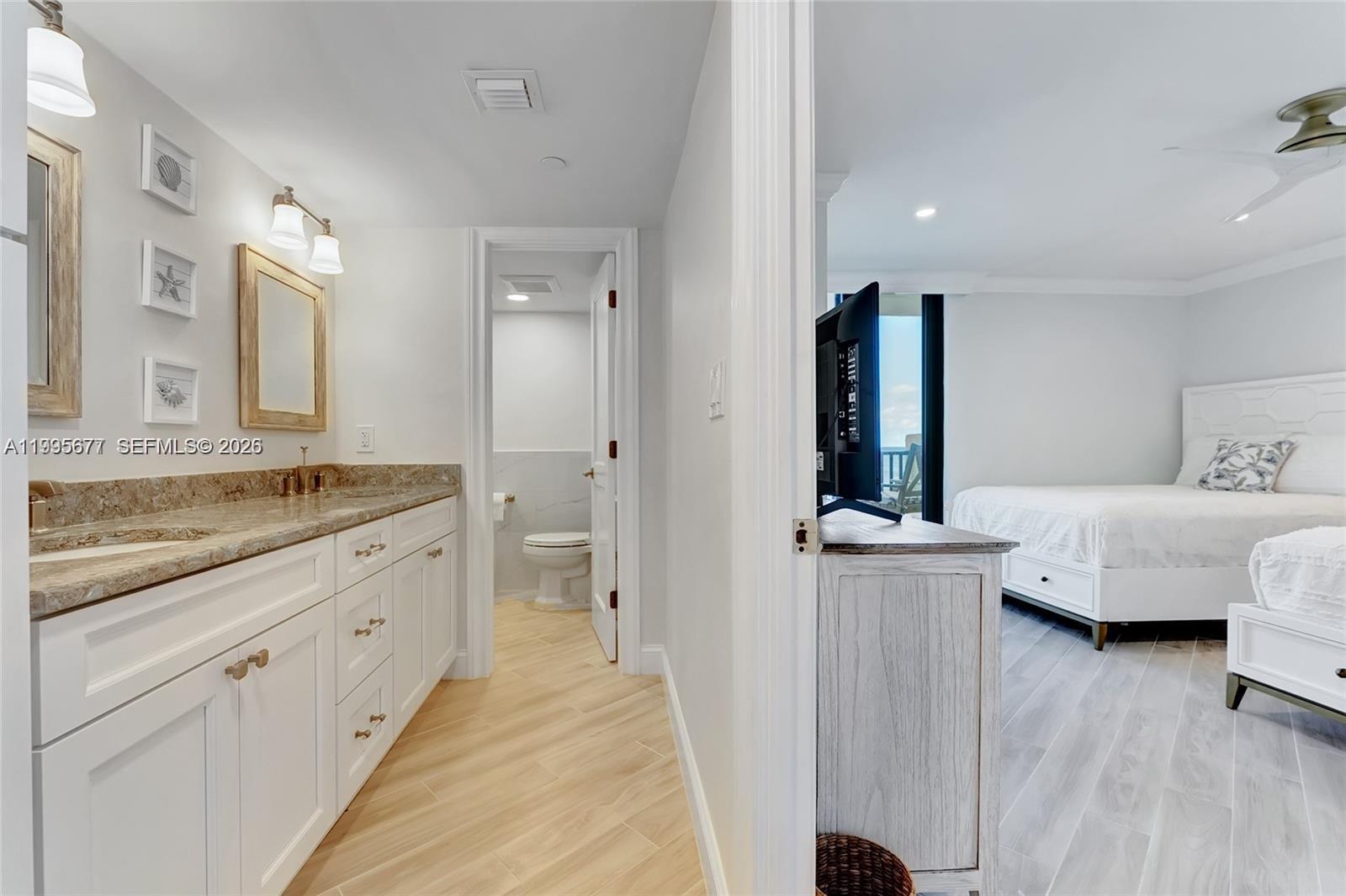 400 Ocean Trail Way, Unit 401 Jupiter, FL 33477 - Photo 25 of 28 a spacious bathroom with a granite countertop sink and a mirror