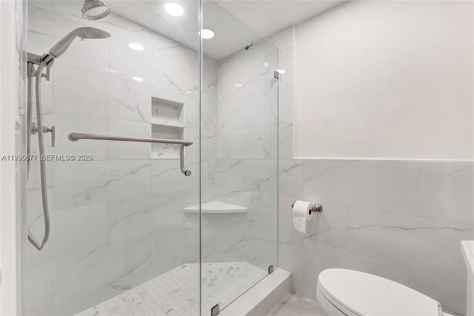 400 Ocean Trail Way, Unit 401 Jupiter, FL 33477 - Photo 26 of 28 a bathroom with a toilet sink and shower