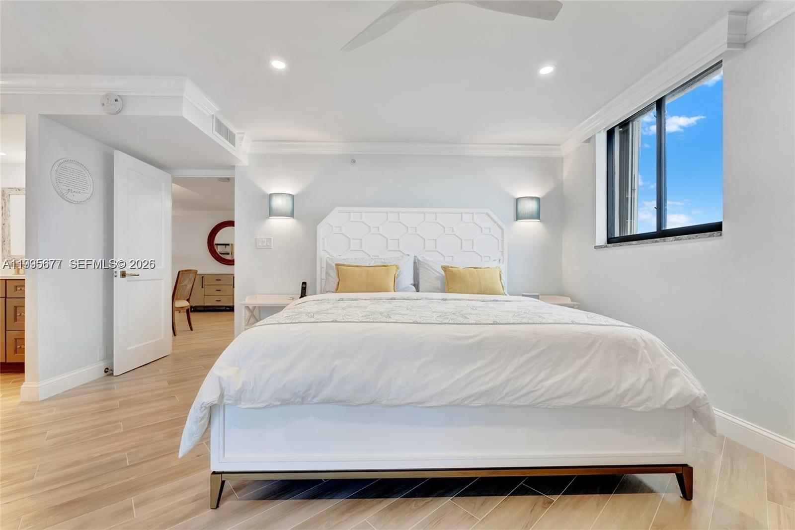 400 Ocean Trail Way, Unit 401 Jupiter, FL 33477 - Photo 7 of 28 a bedroom with a bed and wooden floor