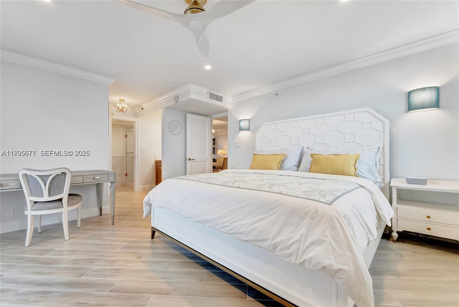 400 Ocean Trail Way, Unit 401 Jupiter, FL 33477 - Photo 8 of 28 a spacious bedroom with a bed a chair and the dresser