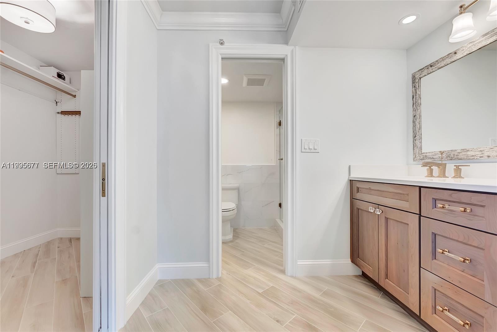 400 Ocean Trail Way, Unit 401 Jupiter, FL 33477 - Photo 9 of 28 a bathroom with a granite countertop sink mirror and vanity