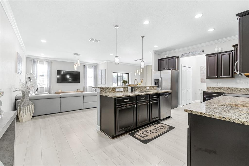 1762 Hadden Hall Place Trinity, FL 34655 - Photo 6 of 49 a kitchen with stainless steel appliances kitchen island granite countertop a refrigerator and a stove top oven