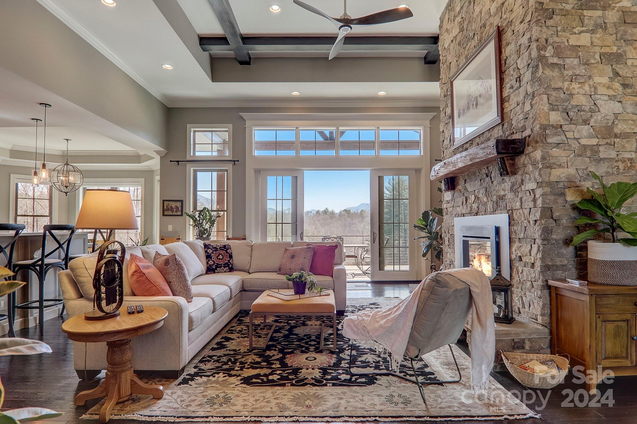 34 Ledgestone Drive Fairview, NC 28730 - Photo 13 of 47 a living room with furniture a fireplace and a chandelier