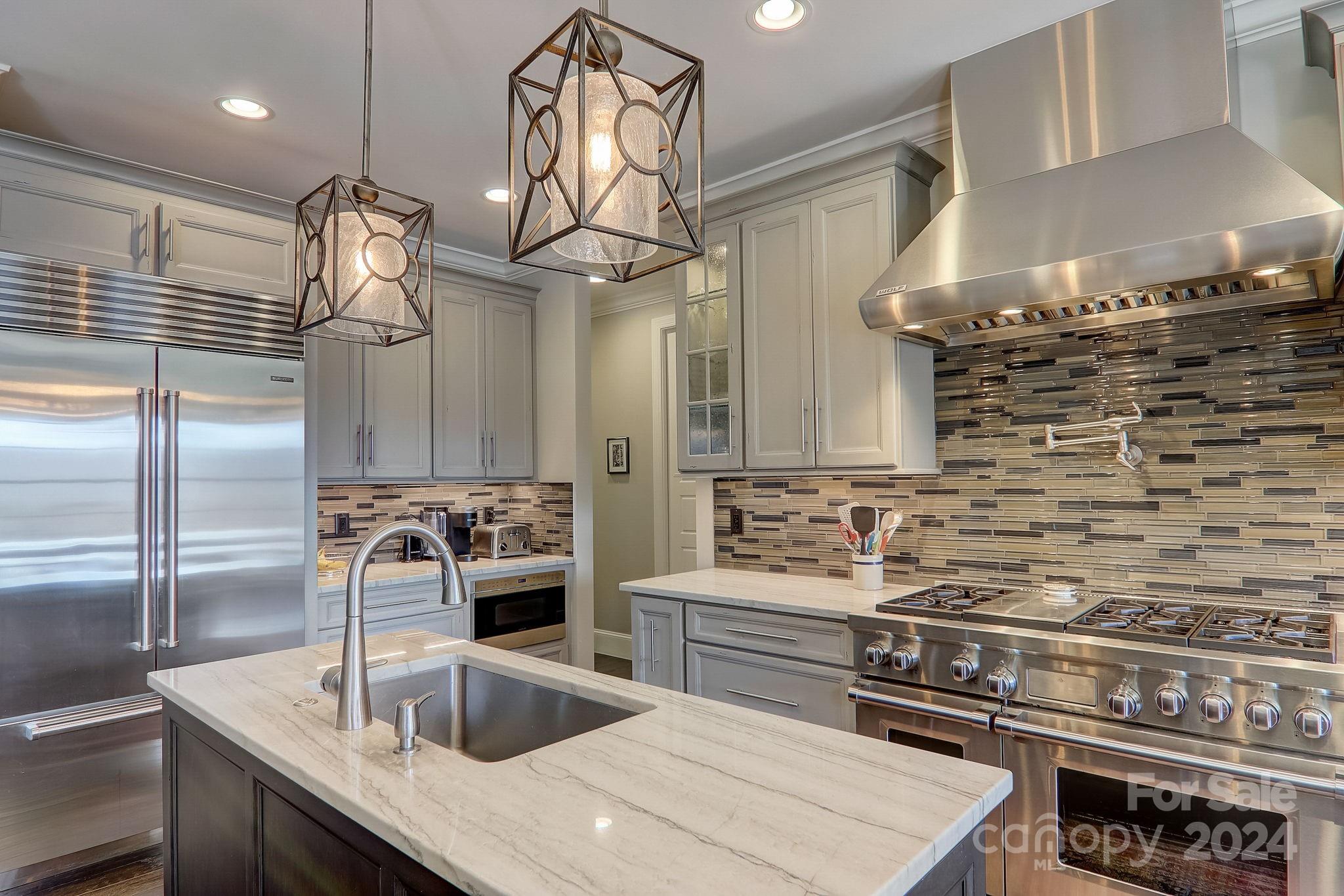 34 Ledgestone Drive Fairview, NC 28730 - Photo 19 of 47 a kitchen with stainless steel appliances a sink a stove and cabinets